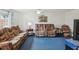 Comfortable living room featuring plush seating, a ceiling fan, and neutral decor at 11762 Barb Ct, Seminole, FL 33778
