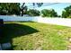 Large, grassy backyard with a white fence offering privacy and plenty of space at 135 Emerald Ln, Largo, FL 33771