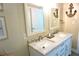 Well-lit bathroom with double sinks, marble countertops, decorative mirrors, and nautical-themed decor at 135 Emerald Ln, Largo, FL 33771