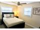 Inviting bedroom with a ceiling fan, a plush bed, and bright natural light at 135 Emerald Ln, Largo, FL 33771