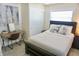 Comfortable bedroom features neutral tones, a ceiling fan, and a convenient workspace at 135 Emerald Ln, Largo, FL 33771