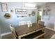 Bright dining room featuring a farmhouse decor and a rustic wooden dining table at 135 Emerald Ln, Largo, FL 33771