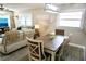 Open concept dining area offering wood flooring and natural light at 135 Emerald Ln, Largo, FL 33771