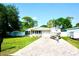 Exterior view of charming single-story home with driveway and boat at 135 Emerald Ln, Largo, FL 33771