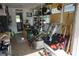 Spacious garage with ample storage, tools, and a door leading to the yard at 135 Emerald Ln, Largo, FL 33771