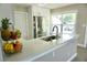 Bright kitchen with stainless steel appliances, white countertop, and ample natural light at 135 Emerald Ln, Largo, FL 33771