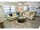 Cozy living room featuring neutral tones, hardwood floors, and comfortable seating at 135 Emerald Ln, Largo, FL 33771
