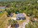 Aerial view of a large home nestled among lush trees on a spacious lot at 15420 Aubrey Ave, Spring Hill, FL 34610