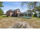 Large backyard featuring a screened in-ground pool on this beautiful two-story home at 15420 Aubrey Ave, Spring Hill, FL 34610