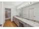 Bathroom featuring a long vanity with marble countertops and ample lighting at 15420 Aubrey Ave, Spring Hill, FL 34610