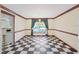 Traditional dining room with checkered floors, natural light, and elegant chandelier at 15420 Aubrey Ave, Spring Hill, FL 34610