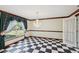 Formal dining room featuring a chandelier, hardwood trim and black and white checkered flooring at 15420 Aubrey Ave, Spring Hill, FL 34610