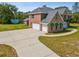 Two-story house featuring a two-car garage, brick accents, and a spacious driveway at 15420 Aubrey Ave, Spring Hill, FL 34610