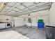 Spacious garage featuring a water heater, washer, and dryer hookups at 15420 Aubrey Ave, Spring Hill, FL 34610