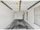 Empty garage with lots of space, natural lighting, and white walls at 15420 Aubrey Ave, Spring Hill, FL 34610