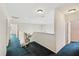 Upstairs hallway with a chair lift and a view of the foyer at 15420 Aubrey Ave, Spring Hill, FL 34610
