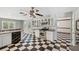 Updated kitchen with stainless steel appliances, white cabinetry, and checkered flooring at 15420 Aubrey Ave, Spring Hill, FL 34610