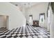 Spacious living room featuring a fireplace, high ceilings, and checkered flooring at 15420 Aubrey Ave, Spring Hill, FL 34610