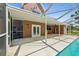 Relax on the screened patio with access to the sparkling in-ground pool at 15420 Aubrey Ave, Spring Hill, FL 34610