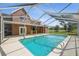Enjoy this refreshing in-ground pool surrounded by a screened enclosure for outdoor relaxation at 15420 Aubrey Ave, Spring Hill, FL 34610