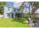 Expansive backyard featuring a screened porch and a cozy fire pit area for outdoor enjoyment at 17734 Long Ridge Rd, Tampa, FL 33647