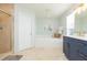 Bathroom with tile floors, shower, tub, and double sink vanity with lots of storage at 17734 Long Ridge Rd, Tampa, FL 33647