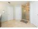 Bathroom with tile floors and shower, next to two doors and a gray bath mat at 17734 Long Ridge Rd, Tampa, FL 33647