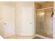 Bathroom with two doors and a glass-door shower at 17734 Long Ridge Rd, Tampa, FL 33647