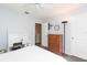 Bedroom with carpet, a desk and shelving unit, with a wooden dresser and lamp at 17734 Long Ridge Rd, Tampa, FL 33647