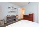 Carpeted bedroom featuring floating shelves, a dresser, and a gray storage cube at 17734 Long Ridge Rd, Tampa, FL 33647
