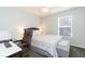 Cozy bedroom featuring a large window, ceiling fan, and neutral decor, providing a serene and inviting atmosphere at 17734 Long Ridge Rd, Tampa, FL 33647