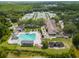 Aerial view of the pool, playground, tennis courts, clubhouse, and lush landscaping at 17734 Long Ridge Rd, Tampa, FL 33647