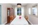 Dining room with a table set for six, wood floors, and decorative mirrors at 17734 Long Ridge Rd, Tampa, FL 33647