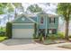 Charming two-story home featuring a well-manicured lawn, a two-car garage, and a welcoming entrance at 17734 Long Ridge Rd, Tampa, FL 33647