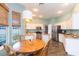 Spacious kitchen with stainless steel appliances, a center island, and wooden dining table at 17734 Long Ridge Rd, Tampa, FL 33647