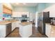 Modern kitchen with white cabinets, granite counters, stainless appliances, and a kitchen island at 17734 Long Ridge Rd, Tampa, FL 33647