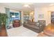 Inviting living room with tile floors, comfortable sofa, and view to kitchen and backyard at 17734 Long Ridge Rd, Tampa, FL 33647