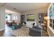 Bright living room featuring bookshelves, hardwood floors, and comfortable seating at 17734 Long Ridge Rd, Tampa, FL 33647