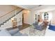 Inviting living room showcasing a staircase, hardwood floors, and comfortable seating arrangements at 17734 Long Ridge Rd, Tampa, FL 33647