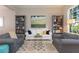 Bright living room features bookshelves, a painting and hardwood floors at 17734 Long Ridge Rd, Tampa, FL 33647