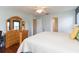 Bright main bedroom with light walls, dresser and an ensuite bathroom at 17734 Long Ridge Rd, Tampa, FL 33647