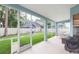 Relaxing screened patio with tiled flooring, offering a comfortable outdoor space with views of the fenced backyard at 17734 Long Ridge Rd, Tampa, FL 33647