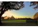 Scenic soccer field view featuring goals, lush green grass, blue sky, and park bench at sunset at 17734 Long Ridge Rd, Tampa, FL 33647