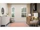 Sunlit Bedroom with modern rocking chair, dresser, and calming decor, perfect for a new baby at 18469 Serene Lake Loop, Lutz, FL 33548