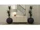 Entryway featuring modern decor, a console table, decorative plants and a view of the staircase at 18469 Serene Lake Loop, Lutz, FL 33548
