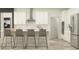 Modern kitchen with stainless steel appliances, white cabinetry, and a breakfast bar with seating at 18469 Serene Lake Loop, Lutz, FL 33548