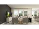 Comfortable living area with large windows, stylish seating, and an open floor plan at 18469 Serene Lake Loop, Lutz, FL 33548