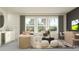 A modern living area with comfortable seating, stylish decor, and a convenient bar area at 18469 Serene Lake Loop, Lutz, FL 33548