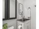 Compact bathroom features a vanity sink, faucet, a mirror, and toilet at 18914 Geraci Rd, Lutz, FL 33548