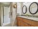 Bright bathroom featuring a dual sink vanity with granite countertop and modern fixtures at 18914 Geraci Rd, Lutz, FL 33548